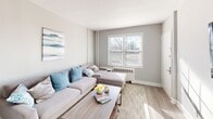 Located at Browning On in Brooklawn, NJ, this single-floor residence offers a thoughtfully designed layout with a neutral color palette and modern updates throughout. The open living and dining area provides a welcoming atmosphere, featuring durable wood-look flooring, soft gray walls, and natural light streaming through a large front-facing window. The sectional seating area flows seamlessly into a defined dining space, making the layout practical for both relaxing and entertaining.

The kitchen has been updated with gray shaker-style cabinetry, quartz countertops, a subway tile backsplash, and stainless steel fixtures and appliances. A built-in open shelf adds a decorative touch while maintaining functionality.

The primary bedroom is generously proportioned, featuring plush carpeting, dual windows that allow ample natural light, and closet access. A second bedroom offers carpeted flooring and a window with natural light, suitable as a guest room or home office. The full bathroom is finished with large-format neutral tiles surrounding a soaking tub and shower combination, complemented by brushed nickel hardware and a window for ventilation. Overall, the residence presents a clean, contemporary aesthetic.