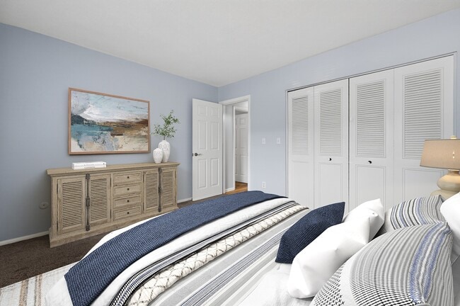 Explore the serene interiors of Park Village West. This well-appointed bedroom features soft hues, ample storage, and a tranquil atmosphere that invites relaxation. Elevate your living experience—come see for yourself today! - Park Village West