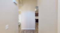 Located at 14520 Village Dr in Fontana, CA, this well-appointed 2-bedroom, 2-bathroom residence offers a comfortable and functional single-floor layout. The combined kitchen and living room serves as the heart of the home, highlighted by a tiled fireplace and sliding glass doors that open to a private balcony, filling the space with natural light and providing outdoor views of the surrounding community. The living area features a combination of wood-style plank flooring and plush wall-to-wall carpeting, adding warmth and texture throughout. A ceiling fan adds comfort to the adjoining area. Each bedroom is carpeted and bright, benefiting from windows with vertical blinds that allow for natural light. The primary bedroom includes its own sliding glass door access to a balcony, offering additional outdoor connectivity. Both bathrooms feature wood-style flooring; one is appointed with a dark-cabinet vanity with a granite-style countertop and a tub-shower combo, while the second offers a clean, functional tub-shower setup. A dedicated closet and hallway complete the thoughtful layout. Textured ceilings are consistent throughout, adding a classic finishing touch to this move-in-ready Fontana home.
