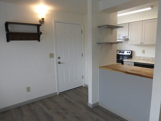Coat rack and wall shelves for storage. - 215 8th St SE