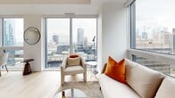 Located in the heart of Montréal on Rue De Bleury, this modern multi-bedroom unit offers a thoughtfully designed open-concept layout finished with light hardwood flooring and a clean, contemporary aesthetic throughout. The living and dining area is bathed in natural light thanks to expansive floor-to-ceiling windows that frame striking panoramic views of the Montréal skyline, creating a bright and airy atmosphere. The kitchen is well-appointed with a combination of white and natural wood cabinetry, a classic subway tile backsplash, stainless steel appliances including a refrigerator, range, and dishwasher, and ample counter space — all flowing seamlessly into the main living area. The bedrooms are comfortably sized, with the primary bedroom benefiting from large windows overlooking the urban cityscape. Hallways are clean and minimalist, featuring recessed lighting and matte black door hardware that add a modern touch. The bathroom is finished in crisp white tile with a soaker tub-shower combination and warm wood cabinetry overhead. Closet space is integrated efficiently throughout. The unit's consistent use of light tones, natural materials, and city-facing windows creates a cohesive, contemporary living environment in one of Montréal's vibrant downtown locations.