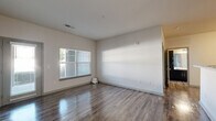 Located at 2550 Pillow Dr in Columbia, TN, this well-appointed one-bedroom, one-bathroom unit offers a thoughtfully designed single-floor layout. The open living and dining areas feature durable hardwood-style flooring, neutral wall tones, and a large window that allows natural light to fill the space. A dedicated dining area flows naturally into the living room, creating a cohesive and functional common area. The galley-style kitchen is equipped with stainless steel appliances—including a refrigerator, microwave, and range—complemented by dark cabinetry, light stone-finish countertops, and a double sink. A separate pantry provides additional storage. The spacious bedroom is finished with plush carpet, a ceiling fan, and a natural light-admitting window, while a walk-in closet offers generous storage. The full bathroom features a tub/shower combination with a curtain rod, a dark-cabinetry vanity with a stone-finish countertop, and hardwood-style flooring. A dedicated laundry room houses a full-size washer and dryer side by side. This unit combines practical functionality with clean, modern finishes throughout.