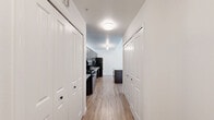Located at 501 Hartsell Ave in Lakeland, Florida, this single-story, 2-bedroom, 1-bathroom home offers a practical and well-appointed layout. The combined kitchen and living area forms the heart of the home, featuring light wood-style flooring that runs throughout. The kitchen is a standout space, equipped with dark espresso cabinetry, granite-style countertops, a subway tile backsplash, and a central island with a matching countertop surface. Black appliances, including a gas range, dishwasher, and refrigerator, complete the kitchen's cohesive design. The living area benefits from natural light through large windows and is equipped with a ceiling fan overhead. Both bedrooms continue the wood-style flooring and are fitted with ceiling fans and windows dressed with vertical blinds, allowing for ample natural light and outdoor views. The shared bathroom is thoughtfully designed with accessibility in mind, featuring stainless steel grab bars throughout, a granite-topped vanity, tile flooring, and a walk-in shower. A hallway connects the rooms, contributing to an efficient and navigable floor plan. The overall aesthetic is clean, modern, and functional, presenting a bright and welcoming living environment.