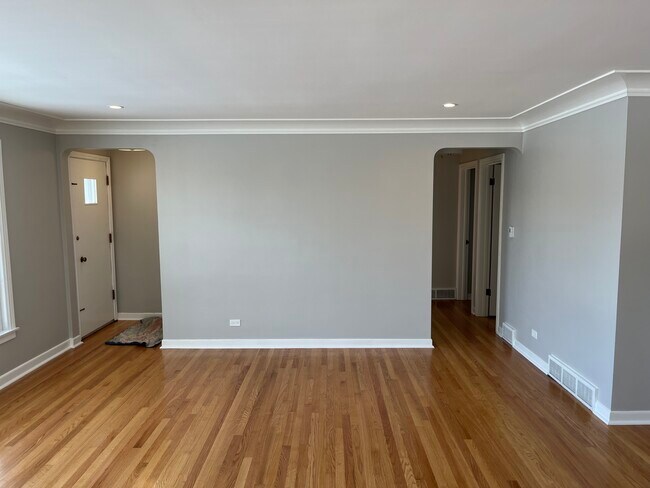 Living room looking at front door and hallway to bedrooms - 6558 N Olympia Ave