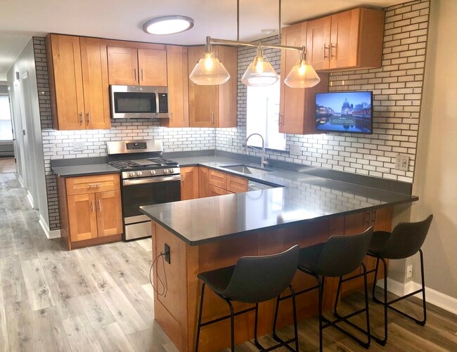 New cabinets, 42” uppers with under lit cabinets, all new S/S Appliances with outdoor vented hood. - 771 56th St