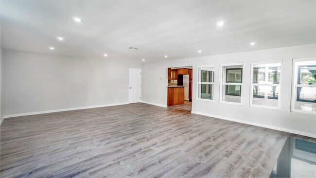 Living area with laundry room on left and kitchen in the center - 3801 Esplanade