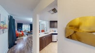Located at Lakepointe Landing in Plantation, FL, this single-floor residence offers three bedrooms and three bathrooms within a thoughtfully designed layout. The open-concept kitchen is a functional centerpiece, featuring dark espresso cabinetry, light countertops, stainless steel appliances including a refrigerator and dishwasher, a skylight, and tile flooring. A pass-through design connects the kitchen seamlessly to the living room, which showcases hardwood-style flooring, track lighting, and large windows dressed with floor-to-ceiling curtains that invite generous natural light. The primary bedroom is a comfortable retreat with a window, wood-style flooring, and access to its own private bathroom, which includes a vanity with a modern vessel mirror and a tub-shower combination. The two additional bedrooms are bright and versatile, each with windows that bring in natural light. The bathrooms are clean and well-appointed with tiled tub-shower combos and vanities. A hallway area provides transitional space between rooms, complemented by closets for storage. The overall ambiance is bright, open, and welcoming, making this residence a well-rounded home in a convenient South Florida location.