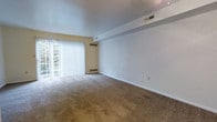 Located at 379 Rivermoor Dr in Marietta, Pennsylvania, this two-floor residence offers a practical and comfortable layout suited for everyday living. The main living area is generously proportioned, featuring wall-to-wall carpeting that adds warmth underfoot and a clean, neutral color palette throughout. A large sliding glass door fitted with vertical blinds allows abundant natural light to fill the room while providing direct access to the outdoors and views of the surrounding greenery. The room benefits from multiple ceiling vents, ensuring consistent climate control throughout the space. The clean white walls and open floor plan create a versatile canvas, easily adaptable to a variety of interior arrangements and design preferences. The two-floor layout provides a clear separation between living and private spaces, adding a sense of organization and privacy to the home. The overall ambiance is bright, open, and move-in ready, with a straightforward design that emphasizes functionality. Situated in the charming borough of Marietta along the Susquehanna River, the property enjoys a peaceful residential setting with convenient access to local amenities.