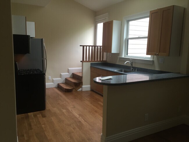 Overall view of kitchen, cabinets, counter and stairs - 326 Utah St
