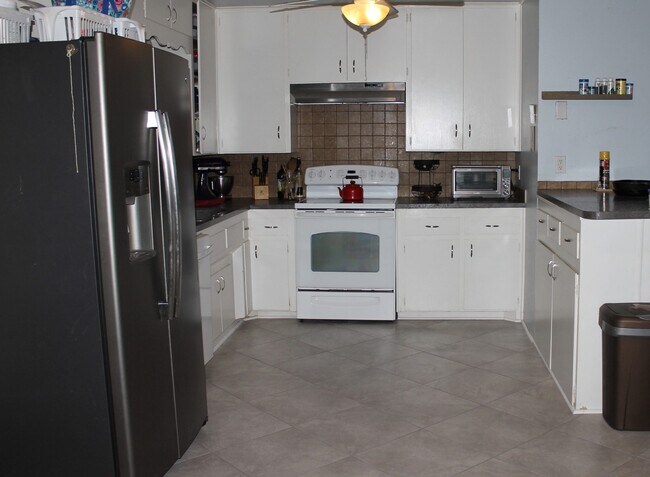 Kitchen open to breakfast room and bonus room - 730 Dezso Dr