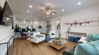 Located on Canary Lane in Bentonville, Arkansas, this single-story space offers a well-organized layout designed for both comfort and functionality. Warm wood-look flooring runs continuously throughout, providing a cohesive foundation across all areas.

The open-concept living and dining area forms the heart of the space. A ceiling fan with integrated lighting anchors the living room, which receives natural light through large windows fitted with white blinds. Recessed lighting supplements the ambiance throughout. The dining area sits adjacent to the kitchen, separated by a peninsula with pendant lighting overhead.

The kitchen is well-appointed with white shaker-style cabinetry, granite-look countertops, and a full suite of stainless steel appliances including a refrigerator, range, microwave, and dishwasher. Ample counter and cabinet space make it highly functional.

A dedicated office room features a large window with natural light, providing a bright and focused workspace. The bedroom is a calm, well-lit retreat with a sizable window overlooking the outdoors. The bathroom continues the design palette with white cabinetry, granite-look countertops, and wood-look flooring. The overall aesthetic is clean, modern, and consistently executed throughout.