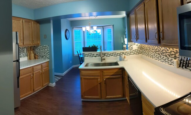 Updated kitchen with deep farm sink with quartz countertops and stainless steel appliances. - 205 Fieldbrook Dr