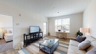 This thoughtfully designed single-floor residence at The Brio At The Boulevard in Yaphank, NY offers a seamless blend of modern aesthetics and functional living. The open-concept layout connects the kitchen, dining, and living areas, creating a cohesive and inviting atmosphere throughout. Wood-style flooring flows across the main living spaces, complementing the bright, neutral color palette that defines the interior.

The kitchen is a standout feature, equipped with crisp white shaker cabinetry, granite countertops, a mosaic tile backsplash, and a full suite of stainless steel appliances including a gas range, built-in microwave, and refrigerator. A peninsula with additional counter space provides a natural divide between the kitchen and the open living area.

The living room is generously proportioned, bathed in natural light from multiple windows with horizontal blinds, and offers a relaxed, versatile setting. The bedroom is a serene retreat, featuring plush carpeting, a large window, and access to a well-organized walk-in closet. The bathroom is finished with granite countertops, white cabinetry, wood-style flooring, and a shower-tub combination. The overall ambiance is clean, contemporary, and move-in ready.