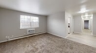 Located at 125 Roxboro Circle in Syracuse, NY, this two-bedroom, two-bathroom unit offers a practical and well-organized single-floor layout. The space is designed for comfortable everyday living, with each room thoughtfully arranged to maximize functionality.

The kitchen is a standout feature, outfitted with crisp white cabinetry, bold dark marble-style countertops, and a window fitted with blinds that allows natural light to brighten the workspace. A baseboard heater and light vinyl flooring complete the kitchen's clean, modern look.

Both bedrooms are carpeted in neutral tones and feature light gray walls, creating a calm and cohesive atmosphere. The primary bedroom is generously sized, offering a closet with bi-fold doors and a window with exterior views. The second bedroom also includes a window with natural light, a closet, and a baseboard heater. Both rooms provide a comfortable and quiet retreat.

The living area features carpet flooring, a wall-mounted air conditioning unit, and a large window that brings in outdoor light and neighborhood views. A hallway connects the main living spaces to the two bathrooms, one of which includes a full tub and shower surround. Baseboard heating is present throughout the unit, ensuring warmth during Syracuse's colder months.