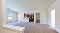 Located at 236 Reserve Way in Harrisburg, Pennsylvania, this one-bedroom, one-bathroom residence offers a thoughtfully designed single-floor layout. The open-concept living area is expansive and bright, featuring neutral-toned carpet and large windows that invite natural light and views of the surrounding greenery. A pass-through connects the living room to the kitchen, creating a cohesive and functional flow throughout the main living space.

The kitchen is a standout feature, boasting rich cherry wood cabinetry, granite countertops, a tile backsplash, hardwood flooring, and a full suite of black appliances including a refrigerator, range, and microwave. A window above the sink further enhances the space with natural light.

The generously sized bedroom offers plush carpeting, a large window with outdoor views, and a dedicated closet with built-in rod storage. The full bathroom features tile flooring, a shower/tub combination, and warm cabinetry that complements the overall design palette.

Additional highlights include a dedicated laundry room with washer and dryer hookups, a private patio for outdoor enjoyment, and a staircase providing access to the unit. Neutral wall tones and consistent finishes throughout create a clean, cohesive ambiance ideal for comfortable everyday living.