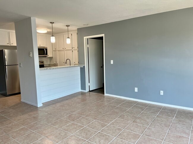 View of kitchen and master bedroom entry off of living room. - 5710 Baltimore Dr