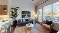 Located at 4600 Ross Ave in Dallas, Texas, this single-floor residence offers a thoughtfully designed living space with modern finishes and a warm, contemporary aesthetic. The open-concept layout connects the living, dining, and kitchen areas seamlessly, creating an inviting flow throughout the home.

The living area features rich hardwood flooring, large windows dressed with patterned drapes that invite abundant natural light, and generous ceiling height that adds to the sense of openness. The kitchen is well-appointed with floor-to-ceiling walnut-toned cabinetry, white quartz countertops, a classic white subway tile backsplash with under-cabinet lighting, and a full suite of stainless steel appliances including a refrigerator, range, microwave, and dishwasher.

The bedroom offers a comfortable retreat with hardwood floors, large windows overlooking outdoor greenery, and ample wall space. The bathroom is finished with clean, neutral tilework, a wood-toned vanity with white countertops and black hardware, a soaking tub with shower combination, and decorative wall accents that add character to the space.

Throughout, the residence maintains a cohesive design language — warm wood tones, crisp white walls, and black hardware accents — delivering a stylish and functional home in the heart of Dallas.