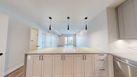 This contemporary 820 square foot apartment in Denver offers a thoughtfully designed living space. The open-concept layout seamlessly integrates the kitchen, living, and dining areas, creating a spacious feel. The kitchen is a highlight, featuring sleek light-colored cabinetry, stainless steel appliances, and a stylish marble-look backsplash. Pendant lighting adds a modern touch.

The bedroom, measuring 170 square feet, provides a comfortable retreat with large windows offering city views. The bathroom showcases a luxurious walk-in shower with marble-effect tiling and a glass enclosure. Throughout the apartment, hardwood flooring adds warmth and elegance.

Ample storage is available with multiple closets, including built-in wardrobes. The apartment benefits from recessed lighting and ceiling fans, enhancing the overall ambiance. A standout feature is the balcony accessible from the living area, perfect for enjoying the Denver skyline.

The neutral color palette, clean lines, and high-end finishes create a sophisticated and inviting atmosphere, making this apartment an ideal urban dwelling in the heart of Denver.