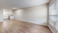 Located at 5870 58th Way N in Kenneth City, Florida, this single-story, 2-bedroom, 1-bathroom home offers a practical and well-appointed layout. Wood-look flooring runs throughout the residence, lending a cohesive and clean aesthetic to every room. The open-concept living, dining, and kitchen area forms the heart of the home, providing a versatile space for everyday living. The living area features neutral walls, a textured ceiling, and natural light from a front-facing window alongside a private entry door. The kitchen is outfitted with crisp white shaker-style cabinetry, white countertops, a stainless steel refrigerator, dishwasher, and range, plus a window above the sink that brings in additional natural light. Both bedrooms are well-proportioned and bright, each featuring windows with blinds, neutral tones, and textured ceilings. The full bathroom includes a tub-shower combination with clean white tile surround and brushed nickel fixtures. Additional highlights include three closets for generous storage, a dedicated laundry area, a utility room, and a hallway that connects the living spaces efficiently. The home's understated, move-in-ready design makes it a functional and comfortable residence.