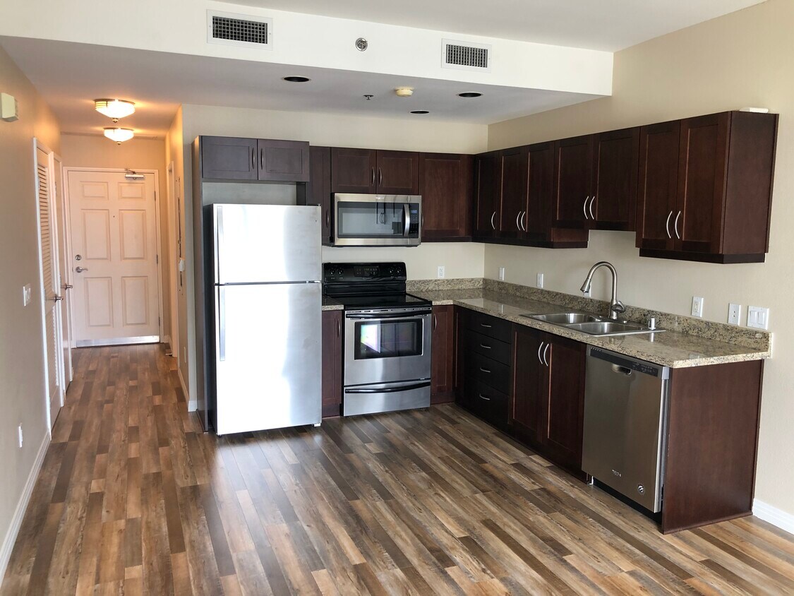 Newly Renovated Kitchen with granite countertops, stainless steel appliances, and wood floors - 427 9th Ave