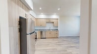 Located at 580 Media Pl in Sacramento, CA, this one-bedroom, one-bathroom unit offers a thoughtfully designed single-floor layout with a clean, modern aesthetic throughout. The kitchen is a standout feature, showcasing light wood cabinetry that extends to the ceiling, granite-style countertops, and a full suite of stainless steel appliances including a refrigerator, range, microwave, and dishwasher. A light-toned hardwood-style floor runs throughout the kitchen and living areas, enhancing the bright, open feel of the space. Recessed lighting adds a polished touch to the kitchen's crisp white walls and ceiling. The bedroom is a comfortable, well-proportioned retreat finished with soft wall-to-wall carpeting and neutral warm-toned walls. Multiple windows fitted with horizontal blinds invite natural light and outdoor views, creating an airy atmosphere. A sliding closet door provides convenient built-in storage. The bathroom features hardwood-style flooring consistent with the rest of the unit, granite-topped vanity cabinetry, a tiled tub-shower combination, and louvered closet doors for additional storage. The overall design of the unit emphasizes clean lines, light tones, and functional finishes that create a fresh and inviting living environment.
