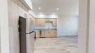 Located at 580 Media Pl in Sacramento, CA, this one-bedroom, one-bathroom unit offers a thoughtfully designed single-floor layout with a clean, modern aesthetic throughout. The kitchen is a standout feature, showcasing light wood cabinetry that extends to the ceiling, granite-style countertops, and a full suite of stainless steel appliances including a refrigerator, range, microwave, and dishwasher. A light-toned hardwood-style floor runs throughout the kitchen and living areas, enhancing the bright, open feel of the space. Recessed lighting adds a polished touch to the kitchen's crisp white walls and ceiling. The bedroom is a comfortable, well-proportioned retreat finished with soft wall-to-wall carpeting and neutral warm-toned walls. Multiple windows fitted with horizontal blinds invite natural light and outdoor views, creating an airy atmosphere. A sliding closet door provides convenient built-in storage. The bathroom features hardwood-style flooring consistent with the rest of the unit, granite-topped vanity cabinetry, a tiled tub-shower combination, and louvered closet doors for additional storage. The overall design of the unit emphasizes clean lines, light tones, and functional finishes that create a fresh and inviting living environment.
