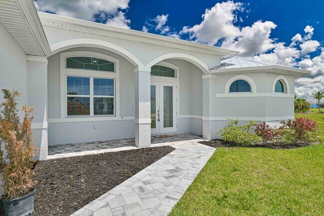 Building Photo - NOW AVAILABLE - Gorgeous Pool Home ~ NW Cape ~ 3 Car Garage ~ On Canal!