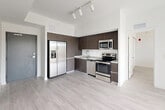 Located at 22555 SW 107th Ave in Miami, FL, this modern single-floor residence offers two bedrooms, two bathrooms, a dedicated laundry area, a utility room, and two closets. The open-concept layout connects the kitchen and living area seamlessly, creating an efficient and functional flow throughout the space. Light wood-style flooring runs throughout, complementing the clean white walls and contemporary aesthetic.

The kitchen is well-appointed with dark espresso-toned cabinetry, granite-style countertops, a white tile backsplash, and a full suite of stainless steel appliances including a French door refrigerator, electric range, built-in microwave, and dishwasher. Track lighting overhead adds a modern touch. A sliding glass door in the living area fills the space with natural light and provides views of the outdoors.

Both bedrooms are bright and airy, each featuring windows with horizontal blinds that allow for adjustable natural light and light wood-style flooring. The two bathrooms are finished consistently with dark vanity cabinetry, granite-style countertops, large mirrors, and shower-tub combos, maintaining the home's cohesive modern design throughout. The overall ambiance is clean, contemporary, and move-in ready.