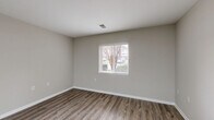 Located at 4048 Battleground Ave in Greensboro, NC, this single-floor, one-bedroom, one-bathroom unit offers a well-organized layout designed for efficient everyday living. The open-concept main area seamlessly integrates the living room, dining area, and kitchen, creating a cohesive and functional space. The kitchen is equipped with granite countertops, a stainless steel undermount sink with a modern brushed-nickel faucet, and stainless steel appliances, including a refrigerator and range. A ceiling fan adds comfort to the main living area, which is brightened by natural light from windows with blinds. Durable wood-style flooring runs throughout the main living spaces, complementing the neutral, warm-toned walls and crisp white trim. The bedroom features plush carpet flooring, a window for natural light, and access to a dedicated closet. The bathroom is fitted with wood-style flooring, a tub/shower combination with accessibility grab bars, and classic white fixtures. A dedicated laundry area includes washer and dryer hookups for added convenience. A hallway connects the rooms, completing this compact and practical layout.