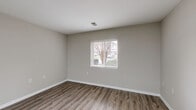 Located at 4048 Battleground Ave in Greensboro, NC, this single-floor, one-bedroom, one-bathroom unit offers a well-organized layout designed for efficient everyday living. The open-concept main area seamlessly integrates the living room, dining area, and kitchen, creating a cohesive and functional space. The kitchen is equipped with granite countertops, a stainless steel undermount sink with a modern brushed-nickel faucet, and stainless steel appliances, including a refrigerator and range. A ceiling fan adds comfort to the main living area, which is brightened by natural light from windows with blinds. Durable wood-style flooring runs throughout the main living spaces, complementing the neutral, warm-toned walls and crisp white trim. The bedroom features plush carpet flooring, a window for natural light, and access to a dedicated closet. The bathroom is fitted with wood-style flooring, a tub/shower combination with accessibility grab bars, and classic white fixtures. A dedicated laundry area includes washer and dryer hookups for added convenience. A hallway connects the rooms, completing this compact and practical layout.