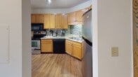 Located at 210 W Grant St in the heart of Minneapolis, MN, this single-floor residence offers a thoughtfully designed layout that balances comfort and urban living. The open living and dining area is a standout feature, showcasing rich hardwood flooring, crisp white walls, and large floor-to-ceiling windows that flood the space with natural light while framing sweeping city views. A sliding glass door leads to a private balcony, extending the living space outdoors.

The kitchen is well-equipped with warm honey-toned cabinetry, granite countertops, a mosaic tile backsplash, and stainless steel appliances including a refrigerator, electric range, built-in microwave, and dishwasher. Track lighting overhead ensures the workspace is well-lit and functional.

The bedroom is generously sized, finished with neutral carpet, a textured ceiling, and a window offering additional city views. A spacious walk-in closet with adjustable wire shelving provides ample storage. The bathroom features classic white tile surrounding the tub-shower combination, a light wood vanity with granite countertop, and mosaic tile flooring. Throughout the residence, clean lines and neutral tones create a cohesive, move-in-ready atmosphere ideal for urban living.
