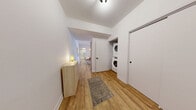 Located at 3555 Saint-Antoine O in Montreal, this well-designed 2-bedroom, 1-bathroom unit offers a clean, contemporary aesthetic throughout. Light oak hardwood flooring flows seamlessly across the single floor, complementing the crisp white walls and modern finishes found in every room.

The open-concept kitchen and dining area serves as a functional hub, featuring dark cabinetry with under-cabinet lighting, white quartz countertops, a white tile backsplash, stainless steel appliances, and a central island with bar seating. The adjacent living room is bright and inviting, with a wall-mounted mini-split system and a large window drawing in natural light.

The primary bedroom is a comfortable retreat, benefiting from floor-to-ceiling windows with outdoor views and its own mini-split unit. The second bedroom is clean and quiet with a built-in closet. A dedicated office space adds valuable flexibility to the layout.

The bathroom is finished to a high standard, with large-format white wall tiles, a glass-enclosed shower with black fixtures, a wood-tone vanity, and a round mirror. The hallway also houses a stacked in-unit washer and dryer for added convenience. Three closets provide ample storage, and a private balcony completes this thoughtfully laid-out home.