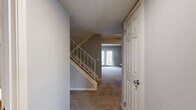 Located at 7950 Village Drive in Cincinnati, Ohio, this two-story home offers a thoughtfully designed layout across two well-proportioned floors. The main level welcomes you through a dedicated entrance that opens to a carpeted living room adorned with crown molding and soft, warm lighting. Adjacent to the living room, the dining area features a tray ceiling with a ceiling fan and flows directly into the kitchen, which is equipped with light wood cabinetry and ample counter space. A bathroom on the main level adds everyday convenience.

The upper floor hosts both bedrooms, including a generously sized primary bedroom with plush carpeting, a large window that invites natural light and outdoor views, and ample closet access. The second bedroom is equally comfortable, with neutral tones and good proportions. The upper level is served by two additional bathrooms, one of which features a full tub and shower combination. A carpeted hallway connects the bedrooms, with a staircase providing easy access between floors.

Throughout the home, neutral gray walls, textured ceilings, and durable flooring choices create a cohesive and move-in-ready aesthetic. With eight closets distributed across both levels, storage is a clear strength of this home.