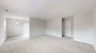 Located at 744 Eayrestown Rd in Lumberton, NJ, this single-floor unit offers a clean, neutral aesthetic throughout. The open living area is carpeted in light beige tones and bathed in natural light through vertical-blind-covered sliding doors, creating an airy and welcoming atmosphere. A separate entry area provides a practical transition into the main living space, which flows seamlessly through the floor plan. The kitchen is well-appointed with white shaker-style cabinetry, light granite countertops, stainless steel appliances including a dishwasher, and wood-look vinyl flooring, delivering a modern yet functional cooking environment. The bedrooms are generously proportioned with plush carpeting and natural light from multiple windows. Each bedroom includes closet storage, with one room also featuring convenient in-unit stacked washer and dryer access alongside an electrical panel. The bathroom is finished with wood-look tile flooring, a white vanity with brushed nickel hardware, and a full tub-shower combination with a bright window above. Throughout the unit, a consistent palette of soft grays and whites contributes to a bright, move-in-ready environment suitable for a variety of living arrangements.