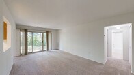 Located at 108 Summit Pointe Dr in Scranton, Pennsylvania, this one-bedroom, one-bathroom residence offers a well-organized single-floor layout designed for comfortable everyday living. The living room is a bright, open space finished with wall-to-wall neutral carpet and crisp white walls. A sliding glass door floods the room with natural light and provides direct access to a private patio with lush outdoor views, creating a seamless indoor-outdoor connection. The galley-style kitchen is efficiently designed with warm oak cabinetry, white countertops, tile flooring, and full appliances including a gas range, dishwasher, and refrigerator. Ample upper and lower cabinet storage maximizes functionality. The kitchen opens toward the dining area, which benefits from a ceiling fan and a window framing natural greenery. The spacious primary bedroom features soft carpeting, natural light from a dedicated window, and notably generous closet space with two separate closets offering substantial storage. The full bathroom is finished with tile flooring, a wide vanity with dual mirrors, and a well-lit Hollywood-style light bar. Two hallways and four closets throughout the unit provide excellent organizational flexibility. The overall aesthetic is clean, neutral, and move-in ready.