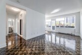 Located at 100 Gloucester St in Toronto's vibrant Church-Wellesley neighbourhood, this one-bedroom, one-bathroom unit offers a well-considered layout across a single floor. The space is characterized throughout by warm, classic parquet wood flooring that adds timeless character to every room.

The living room is the centerpiece of the unit, bathed in abundant natural light through a wide bank of windows that frame views of the surrounding cityscape. A sliding door provides direct access to a private balcony, seamlessly connecting the interior to the outdoors. The open, airy feel of this room makes it an inviting and versatile living area.

The kitchen is efficiently designed with crisp white cabinetry, a white subway tile backsplash, and light-toned tile flooring. A stainless steel sink and integrated dishwasher complete the functional layout, while recessed track lighting ensures the space is well-illuminated.

The bedroom is a comfortable, well-proportioned retreat, also featuring the signature parquet flooring. A mirrored sliding-door closet enhances the sense of space and provides practical storage, while a window allows for natural light and city views.

The bathroom is finished to a clean, classic standard with full white subway tile wall surround, a soaking bathtub with handheld shower, a vanity with under-sink storage, and neutral stone-look tile flooring. The overall ambiance of the unit is bright, clean, and well-maintained.