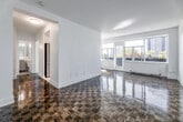 Located at 100 Gloucester St in Toronto's vibrant Church-Wellesley neighbourhood, this one-bedroom, one-bathroom unit offers a well-considered layout across a single floor. The space is characterized throughout by warm, classic parquet wood flooring that adds timeless character to every room.

The living room is the centerpiece of the unit, bathed in abundant natural light through a wide bank of windows that frame views of the surrounding cityscape. A sliding door provides direct access to a private balcony, seamlessly connecting the interior to the outdoors. The open, airy feel of this room makes it an inviting and versatile living area.

The kitchen is efficiently designed with crisp white cabinetry, a white subway tile backsplash, and light-toned tile flooring. A stainless steel sink and integrated dishwasher complete the functional layout, while recessed track lighting ensures the space is well-illuminated.

The bedroom is a comfortable, well-proportioned retreat, also featuring the signature parquet flooring. A mirrored sliding-door closet enhances the sense of space and provides practical storage, while a window allows for natural light and city views.

The bathroom is finished to a clean, classic standard with full white subway tile wall surround, a soaking bathtub with handheld shower, a vanity with under-sink storage, and neutral stone-look tile flooring. The overall ambiance of the unit is bright, clean, and well-maintained.