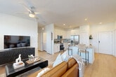 Located at 10203 Karsten Blvd in Rosharon, TX, this well-designed single-story home offers a thoughtful layout across a comfortable footprint. The open-concept living, dining, and kitchen area forms the heart of the home, anchored by light hardwood-style flooring that runs throughout. Large windows flood the living room with natural light and offer pleasant outdoor views, while a ceiling fan adds year-round comfort.

The kitchen is outfitted with crisp white shaker cabinetry, a subtle tile backsplash, granite countertops, and a full suite of stainless steel appliances including a French door refrigerator, range, and over-the-range microwave. A central island with seating provides both additional prep space and a casual dining option alongside the dedicated dining area.

The bedroom is a serene retreat featuring a ceiling fan, a generous window with outdoor views, and cozy carpeting. It connects conveniently to the laundry area. The bathroom is finished with white cabinetry, granite countertops, and a tiled tub-shower combination. Ample storage is provided through four closets, including a spacious walk-in with wire shelving systems, as well as a dedicated pantry. The layout is completed by a hallway that connects all areas efficiently, creating a cohesive and functional living environment.