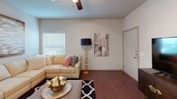 Located at 303 SE Ranger in Bentonville, Arkansas, this single-story 2-bedroom, 1-bathroom home offers a thoughtfully designed layout with a comfortable, modern feel throughout. The open-concept kitchen and living area serves as the heart of the home, featuring rich wood-tone cabinetry, granite-style countertops, a full suite of stainless steel appliances including a refrigerator, electric range, microwave, and dishwasher, and durable hardwood-style flooring. A breakfast bar provides additional seating, while a ceiling fan overhead adds both style and function. In-unit laundry is conveniently accessible just off the kitchen. The living room offers generous space, natural light from a large window, and ceiling fan, creating a welcoming atmosphere for relaxing or entertaining. Both bedrooms are carpeted and feature ceiling fans, windows with natural light, and closet storage. The primary bedroom is a comfortable retreat with ample room to furnish. The bathroom includes a tub-shower combination with sliding glass doors, wood-tone cabinetry, and hardwood-style flooring. A hallway connects the bedrooms and bathroom, completing this efficiently designed and move-in-ready home.