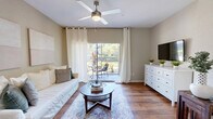 Located at 7855 E Fletcher Ave in Temple Terrace, FL, this well-appointed one-bedroom unit offers a thoughtfully designed single-level layout. Rich hardwood flooring flows throughout the open-concept living, dining, and kitchen areas, creating a warm and cohesive feel. The living room is bright and inviting, featuring a ceiling fan, a sliding glass door that opens to an outdoor patio with lush greenery views, and ample space for comfortable furnishings. The kitchen is equipped with stainless steel appliances — including a full-size refrigerator and range — white cabinetry, a double-basin sink, and a peninsula counter that connects seamlessly to the dining area. The dining nook provides an intimate setting ideal for everyday meals. The bedroom is a calm retreat, finished with plush carpeting, a natural light-filled window with sheer curtains, and a ceiling fan. A dedicated in-unit laundry room includes a full-size washer and dryer alongside built-in shelving for added storage. With a neutral color palette and clean finishes throughout, this space offers a comfortable and functional living environment in the heart of Temple Terrace.