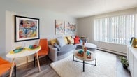 Located at 3815 Lakehurst Dr in Colorado Springs, Colorado, this single-floor unit offers a well-organized layout designed for comfortable, everyday living. The living area serves as the heart of the home, featuring wood-style flooring, a textured ceiling, and a large window with vertical blinds that allows generous natural light to fill the space. A baseboard heating unit and wall-mounted air conditioning provide year-round climate control. The open feel is enhanced by neutral wall tones that complement the room's versatile layout.

The galley-style kitchen runs parallel along one wall, featuring white cabinetry with brushed hardware, a stainless steel sink, and black appliances including a refrigerator and range with overhead ventilation. Wood-style flooring continues throughout, creating a cohesive flow between spaces.

The bedroom is carpeted and well-proportioned, with a large window that brings in natural light. Built-in floor-to-ceiling closet panels offer ample storage, making the room both functional and comfortable.

The bathroom includes a tub-shower combination with a bold patterned curtain, a toilet, and a wall-mounted vanity mirror. Wood-style flooring extends into this space, maintaining a consistent aesthetic throughout the unit.