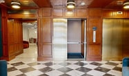This 2690 square foot space in Brookline, MA showcases a blend of functionality and contemporary design. The interior features a striking entrance with a checkered marble floor, teal ceiling, and wooden accents, creating an inviting atmosphere. A spacious lounge area boasts a blue ceiling, modern lighting fixtures, and a mix of seating options including leather couches and wooden chairs. The walls are adorned with artistic elements, combining abstract paintings and textured wallpapers.

The facility includes a well-equipped laundry room with multiple washers and dryers, painted in a vibrant teal color scheme. A fitness center is available, offering various exercise equipment for residents' convenience. Storage areas with shelving units provide ample space for residents' belongings.

The property also features a cozy seating nook with plush velvet seating and artistic wall coverings, perfect for relaxation. A kitchenette area with modern appliances and cabinetry adds to the convenience of the space. The overall design emphasizes a balance between functionality and aesthetic appeal, with attention to detail in lighting, color schemes, and furnishings throughout the various areas of this multi-purpose residential facility.