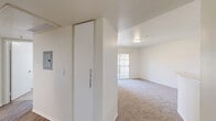 Located at 8507 Magnolia Ave in Riverside, California, this single-floor, 2-bedroom, 1-bathroom unit offers a functional and well-appointed layout. The kitchen is a standout feature, equipped with stainless steel appliances including a range and refrigerator, white cabinetry providing ample storage, a double-basin sink, and wood-style plank flooring. A track lighting fixture overhead adds a modern touch to the space.

Both bedrooms are finished with plush carpeting and feature vertical-blind windows that allow natural light to filter in while offering views of the surrounding neighborhood. The primary bedroom includes a built-in sliding-door closet and direct access to the bathroom, making it a practical and connected space. The second bedroom is comparably sized and similarly bright.

The bathroom is clean and contemporary, featuring a white vanity with generous counter space, multiple drawers for storage, a well-lit mirror, and wood-style flooring that ties back to the kitchen aesthetic. A walk-in shower with a glass enclosure is also present.

A connecting hallway links the rooms efficiently, contributing to the unit's cohesive and easy-to-navigate floor plan. Neutral wall tones and consistent finishes throughout lend the space a clean, move-in-ready appearance.