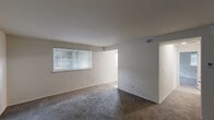 Located at 2700 Boulevard Dr in Elsmere, Delaware, this one-bedroom, one-bathroom unit offers a practical and well-organized single-floor layout. The living room is a generously proportioned space finished with wall-to-wall carpet and a window fitted with blinds that allows natural light to fill the room. A dedicated entryway door provides direct access to this main living area, which connects to the rest of the unit through a central hallway.

The kitchen features wood-look plank flooring, dark espresso-toned cabinetry with ample upper and lower storage, light-colored countertops, and white appliances including an electric range and over-the-range microwave. A window above the counter area brings in additional natural light.

The bedroom is a comfortable, carpeted room with a window for natural light, a built-in double-door closet for storage, and ceiling ventilation. The unit also includes four closets in total, providing notable storage capacity throughout. 

The full bathroom is cleanly finished with wood-look flooring, a white vanity with under-sink storage, a medicine cabinet mirror, and a tub-shower combination. A utility room rounds out the layout, adding functional space for household needs. Overall, the unit presents a clean, neutral palette throughout.