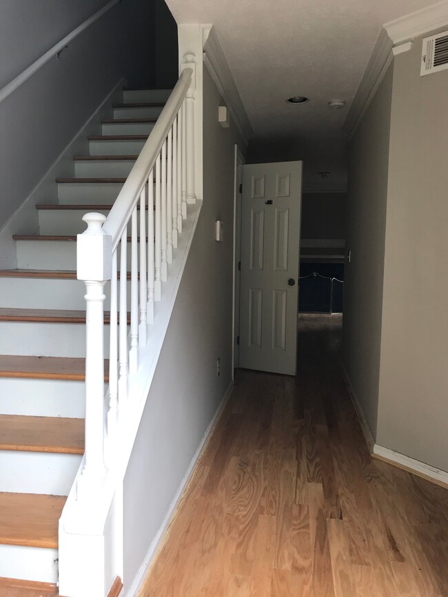 Hallway entering the house leading to bathroom, kitchen, and living room. - 107 Swanton Hill Ct