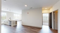 Located at 900 E Six Forks Rd in Raleigh, NC, this well-appointed single-floor residence offers three bedrooms and three full bathrooms within a thoughtfully designed layout. The open-concept kitchen and living area serves as the heart of the home, featuring white shaker cabinetry, quartz countertops with a dual-basin sink, a blue tile backsplash, stainless steel appliances, and a large window that floods the space with natural light. Rich hardwood-style flooring runs throughout the main living areas, complementing the bright, neutral color palette. The bedrooms are generously sized, with plush carpeting, ceiling fans, and large windows offering pleasant outdoor views. One bedroom features hardwood-style flooring, adding versatility to the room configurations. The bathrooms are finished with white vanities, large mirrors, and clean, modern fixtures. A dedicated in-unit laundry room houses a full-size washer and dryer with overhead cabinet storage for added convenience. A closet provides additional organization. Throughout the residence, recessed lighting, ceiling fans, and abundant natural light contribute to a comfortable and functional living environment well-suited for everyday life in Raleigh.