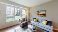 Located at 700 Emerald St SE in Saint Paul, Minnesota, this single-floor residence offers a thoughtfully designed layout that balances comfort and functionality. The living room is a welcoming space highlighted by large windows that frame outdoor views of the surrounding neighborhood, allowing ample natural light to fill the room. Warm hardwood-style flooring runs throughout the main living areas, complementing the neutral-toned walls and creating a cohesive aesthetic.

The kitchen is well-equipped with warm maple cabinetry, white appliances including a range, microwave, dishwasher, and refrigerator, as well as generous counter space and a central island with seating — ideal for casual dining or meal preparation. Recessed lighting overhead enhances the bright, clean atmosphere.

The bedroom is a calm, carpeted retreat featuring a large window with outdoor views and ample wall space, providing a quiet and restful environment. A closet with a panel door offers practical storage.

The bathroom is finished with a dual-sink vanity topped in white, maple cabinetry below, a large mirror with vanity lighting, a walk-in shower, and tile flooring — combining style with everyday convenience. Overall, this residence presents a clean, modern interior with functional spaces suited for comfortable daily living.