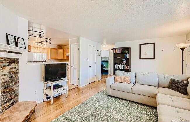 Living Room with wood burning fireplace - 9360 Lowell Blvd