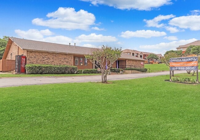 Beautifully landscaped grounds with open green lawns and shade trees. - Sierra Nevada