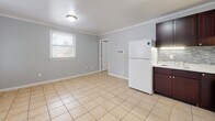 This 440 square foot apartment in North Chesterfield, VA, offers a well-designed living space on a single floor. The layout efficiently accommodates one bedroom (140 sq ft), one bathroom, a kitchen, and a closet. Throughout the apartment, beige tile flooring provides a neutral base, complemented by light gray walls and white trim for a clean, modern aesthetic.

The kitchen is a standout feature, boasting dark wood cabinetry contrasting with white appliances, including a refrigerator, stove, and washer/dryer unit. A stylish backsplash adds visual interest, while ample counter space ensures functionality.

The bedroom, measuring 140 square feet, offers plenty of space for a comfortable sleeping area. Large windows in each room flood the space with natural light, creating an airy atmosphere. The bathroom, while compact, is well-appointed with a white vanity and modern fixtures.

Crown molding throughout adds a touch of elegance, elevating the overall design. The apartment's layout maximizes the use of space, making it an ideal choice for singles or couples seeking a cozy yet functional living environment in an accessible location.